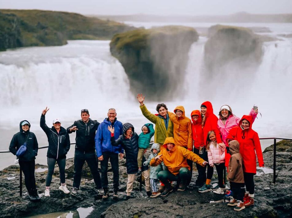 Worldschooling families at a waterfall on an excursion