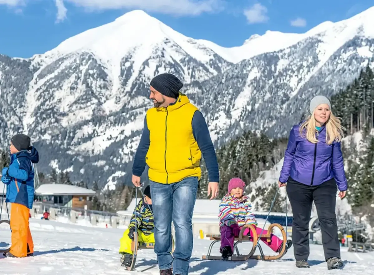 A family out in the snow in the valley