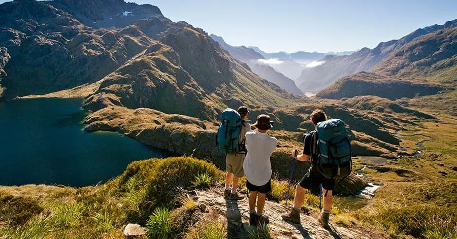 Hikers looking out over a New Zealand lake
