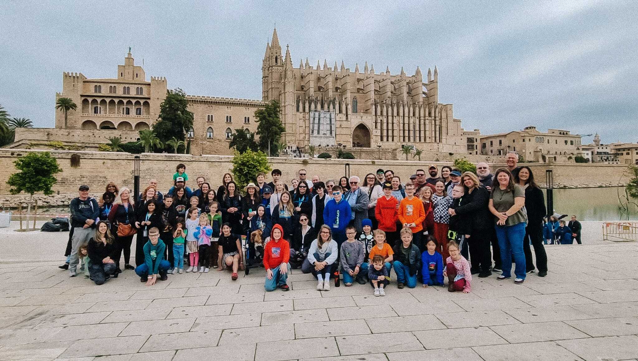 Group of families and children visiting landmarks during worldschooling journeys in Europe.
